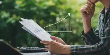 Person reviewing financial documents with green bond investment growth charts