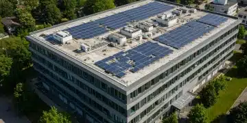 Modern office building with solar panels and green landscaping, representing federal incentives for renewable energy.
