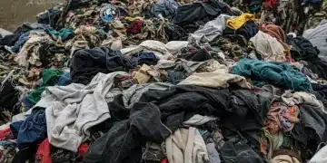 Piles of textile waste in a landfill, symbolizing the environmental challenge addressed by EPA regulations.